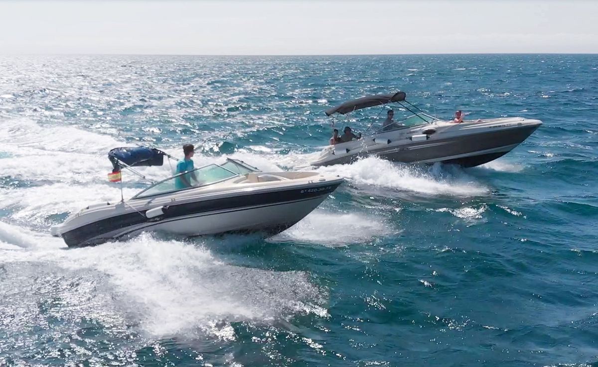 Two Sea Ray boats at speed side by side
