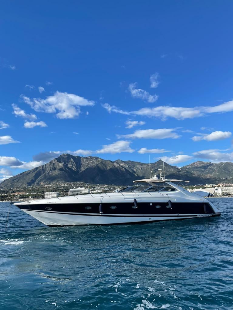 Sunseeker Predator 63 under way, mountains behind